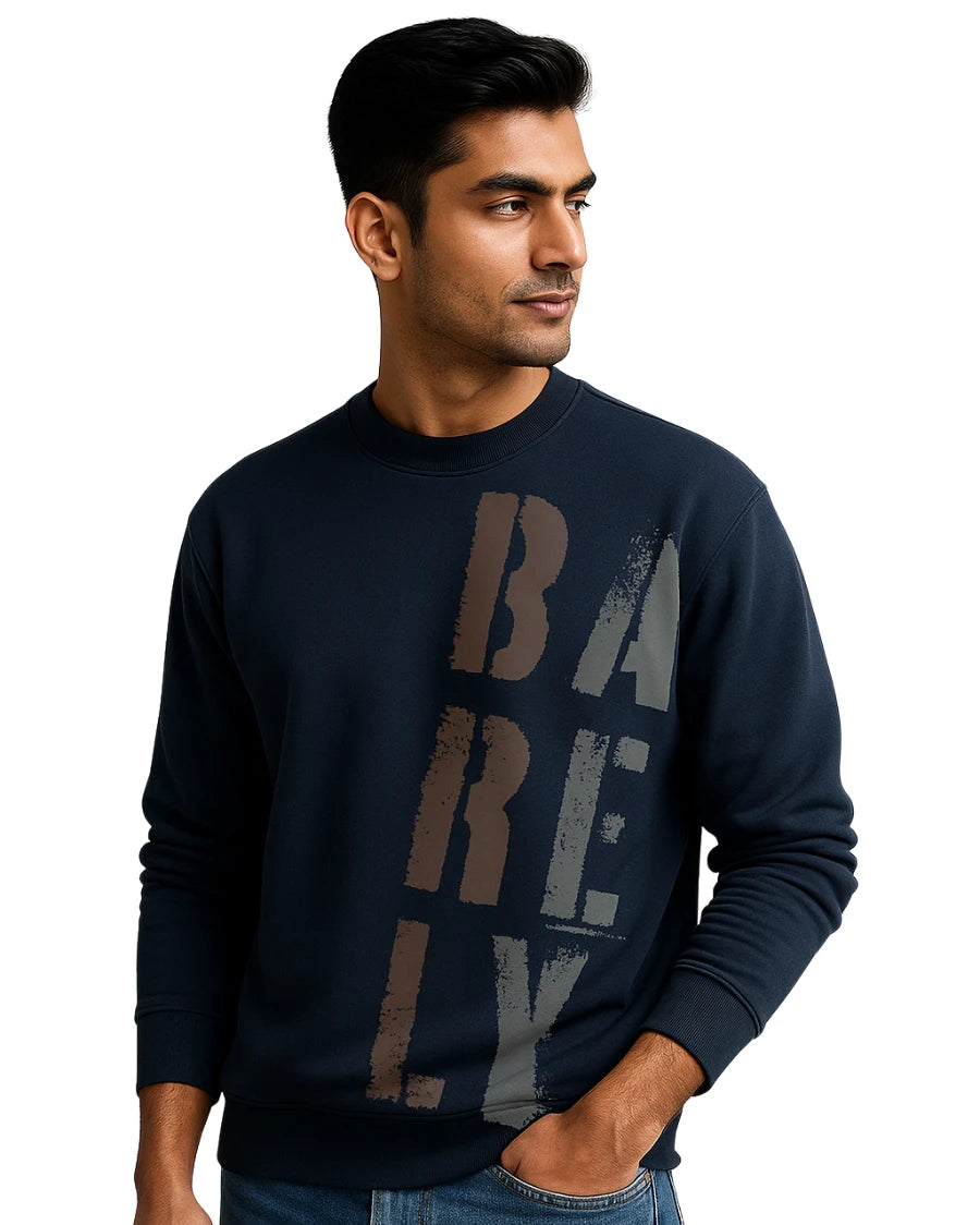 Man wearing a navy blue sweatshirt with 'BARELY' text on a white background