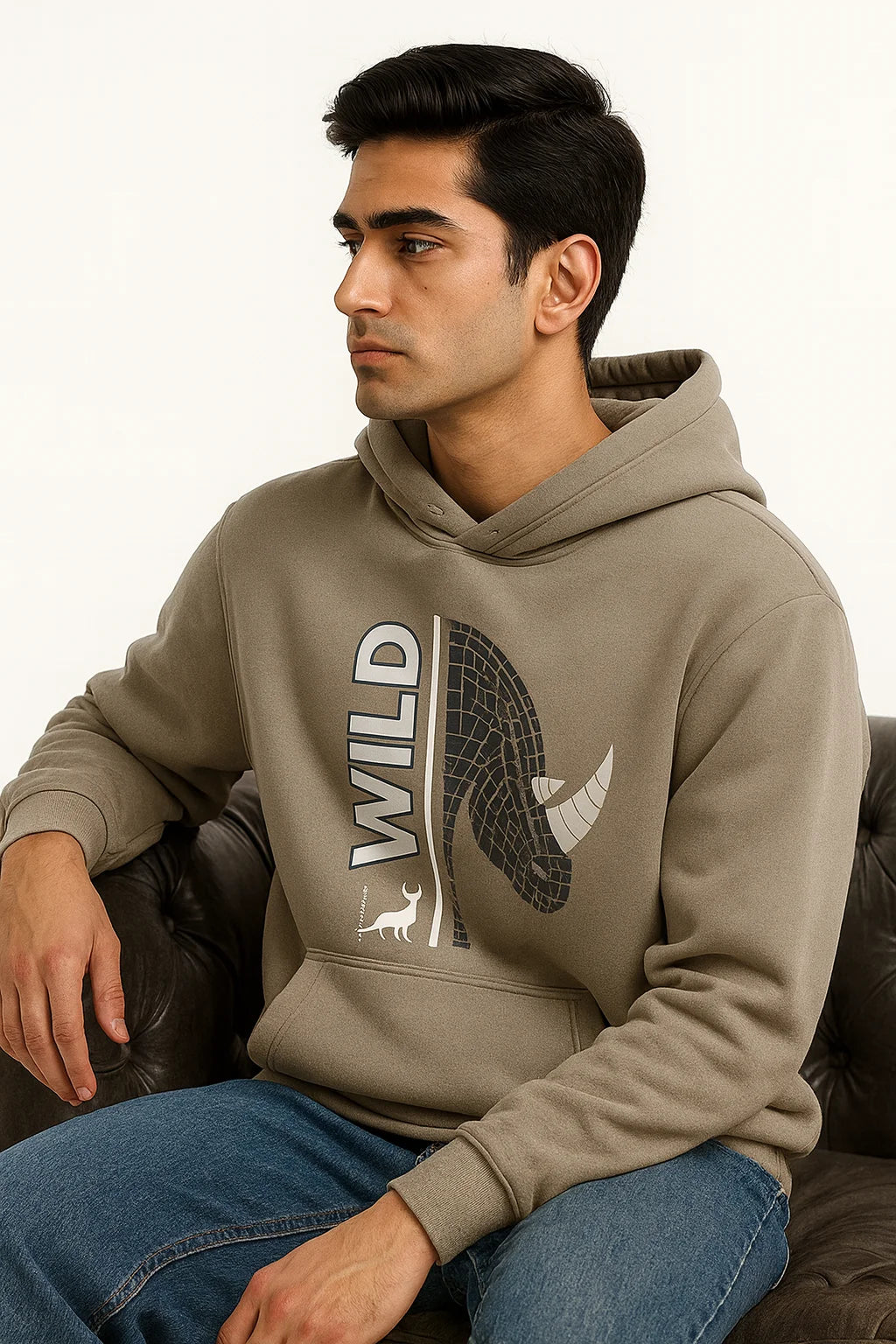 Man wearing a Grey hoodie with a horse and 'WILD' design, sitting on a brown couch.