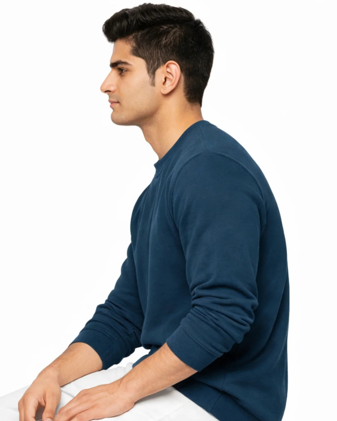 Man wearing a blue long-sleeve shirt on a white background