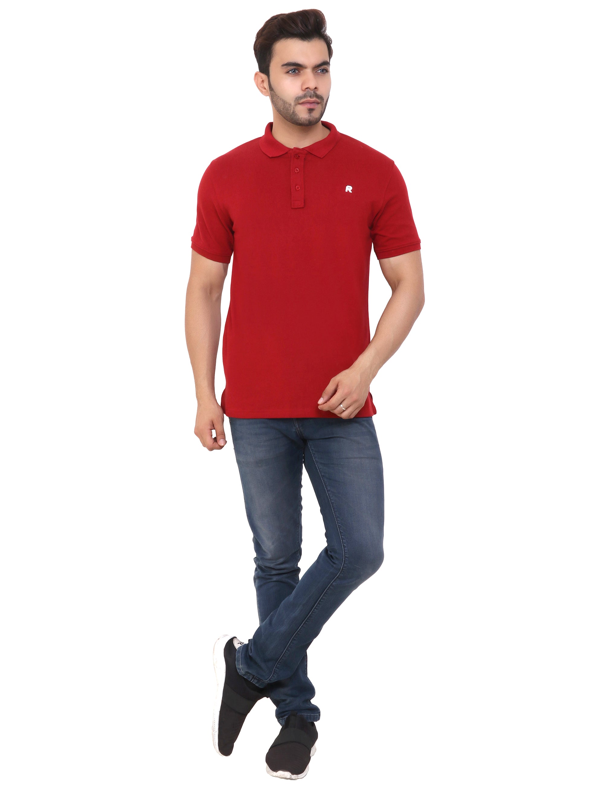 A man wearing a maroon cotton blend polo t-shirt with short sleeves, paired with blue jeans and black shoes.