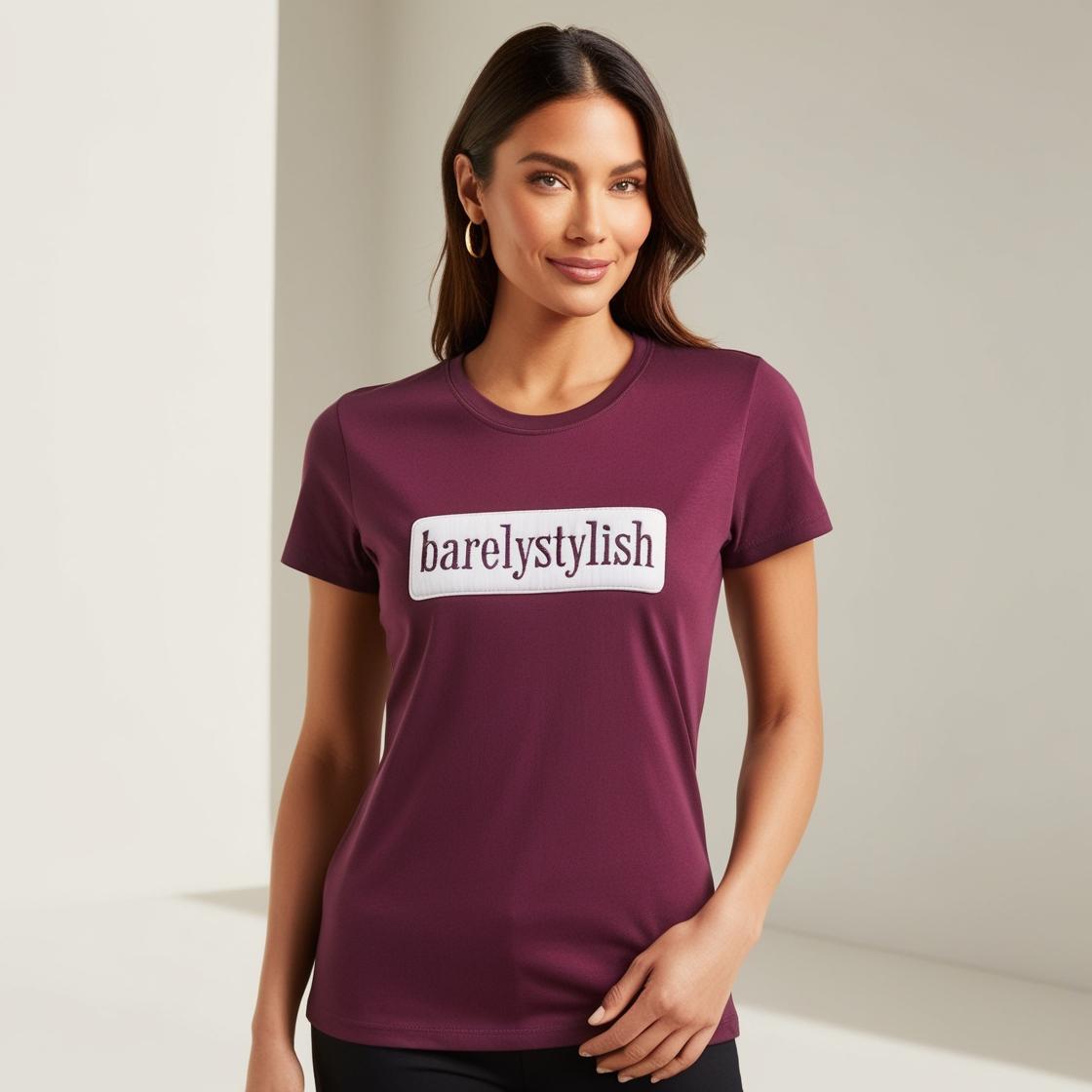 A woman wearing a purple cotton t-shirt with the text 'barelystylish' on it.