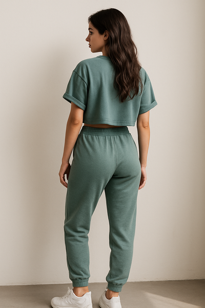 Person wearing a green tracksuit against a plain background