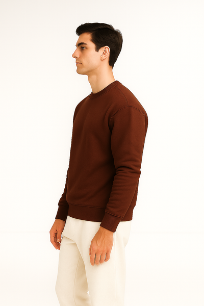 Man wearing a brown sweatshirt and white pants.