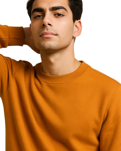 Man wearing an orange sweater against a white background