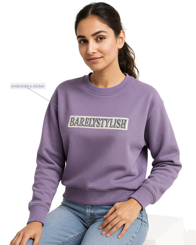 Women wearing a purple sweatshirt with 'BARELYSTYLISH' .