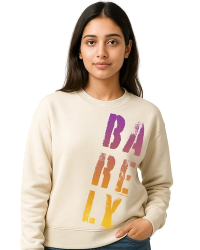 Woman wearing a cream sweatshirt with colorful text on a white background