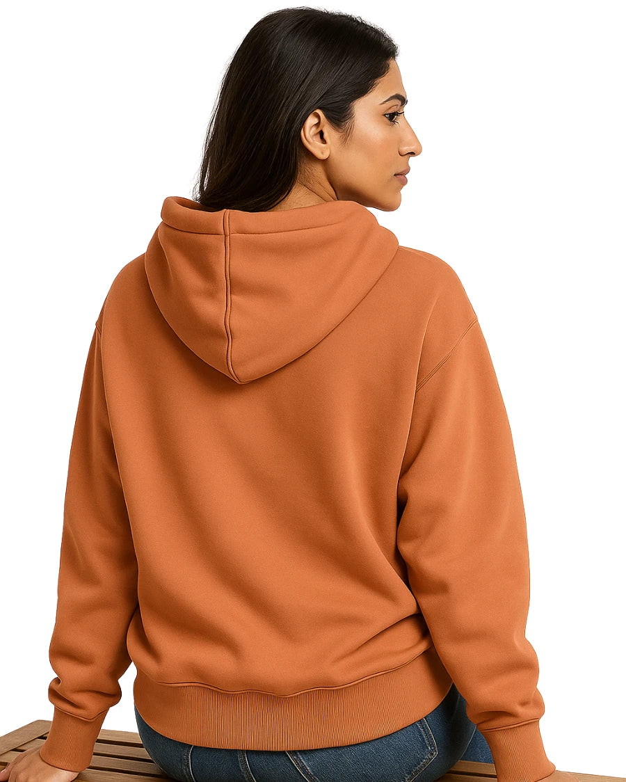 Person wearing a light orange hoodie on a white background