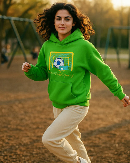 Woman wearing a green hoodie with a soccer design on a playground