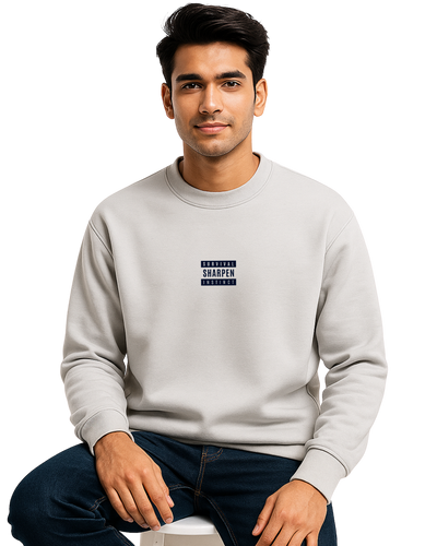 Man wearing a light gray sweatshirt with text on a white background