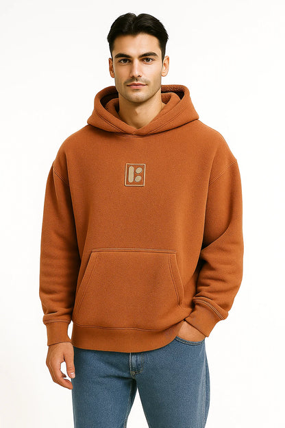 Front Profile of a man wearing a brownish Orange hoodie with a BarelyStylish logo