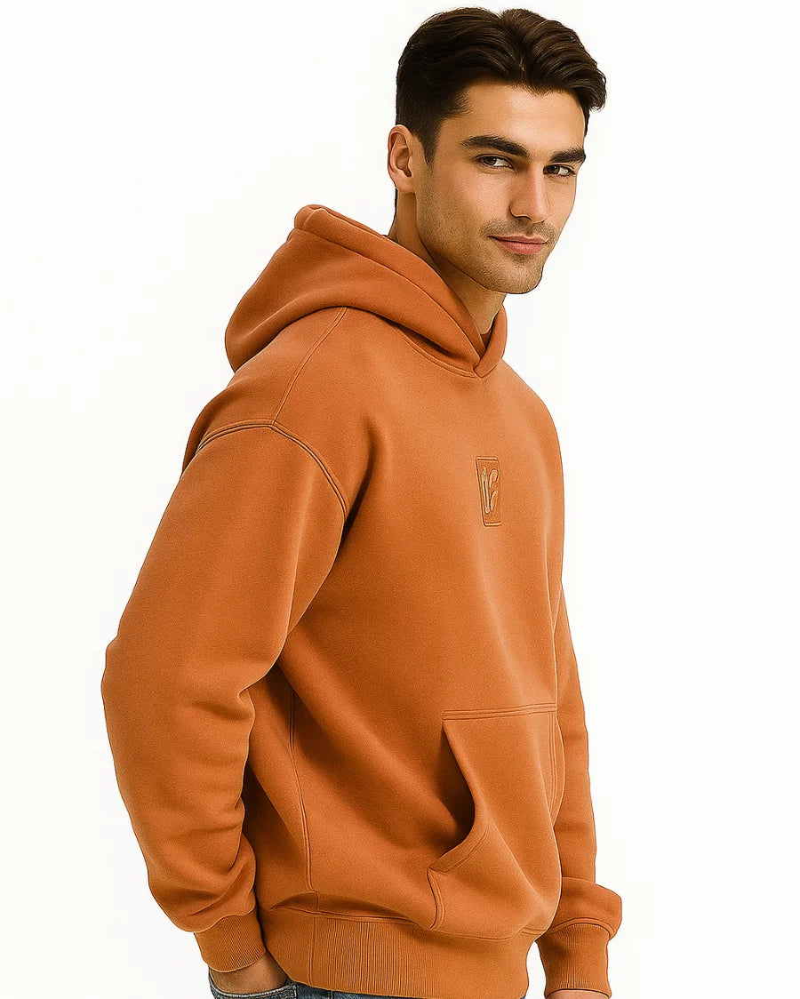 Side Profile of man wearing a brownish Orange hoodie with a BarelyStylish logo