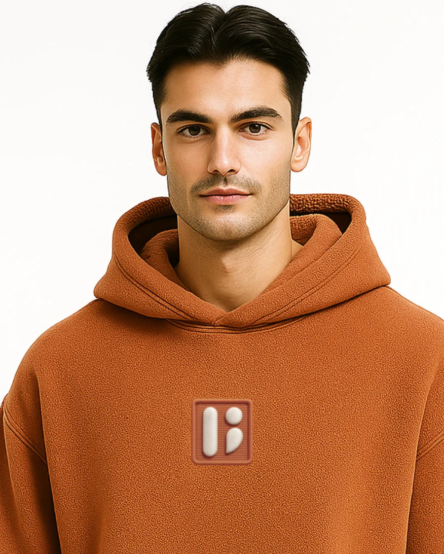 Man wearing a brownish Orange hoodie with a BarelyStylish logo