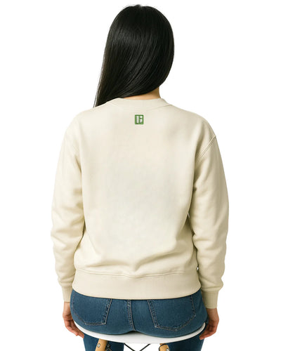 Person wearing a beige sweatshirt with a logo on the back