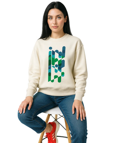 Woman wearing a cream sweatshirt with a colorful geometric design, sitting on a white stool.