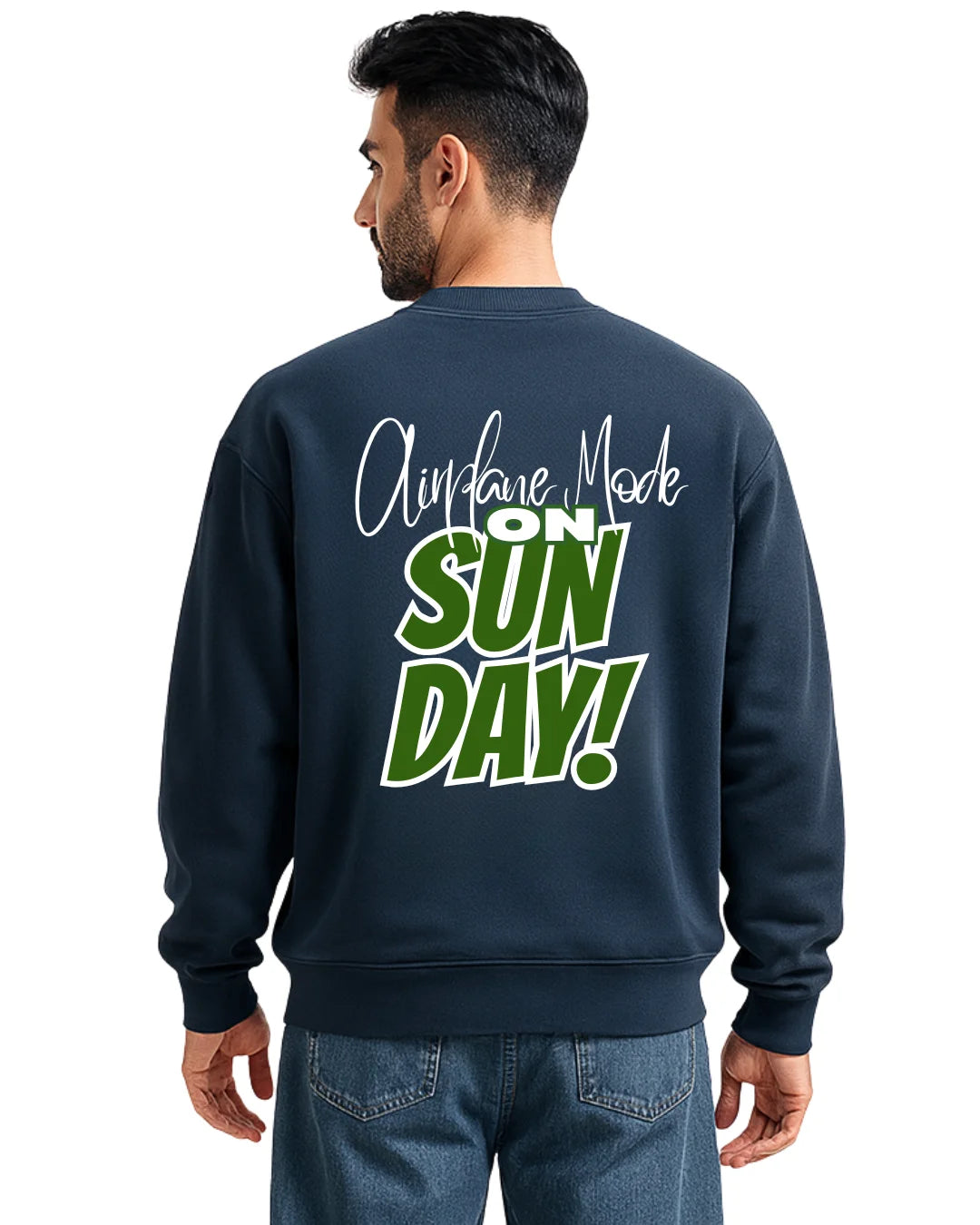 Man wearing a navy sweatshirt with text on the back, standing against a white background