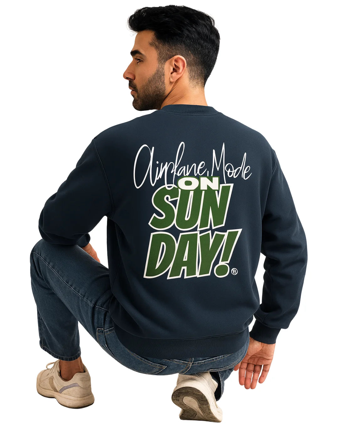Man wearing a navy sweatshirt with 'Airplane Mode ON Sunday!' text on the back, sitting against a white background.