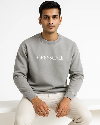 Man wearing a gray sweatshirt with 'GREYSCALE' text on a white background