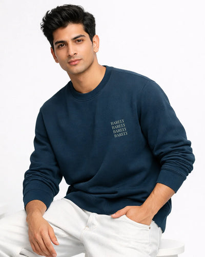 Man wearing a navy blue sweatshirt with text on a white background