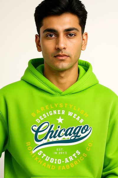 Man wearing a bright green hoodie with text on a plain background