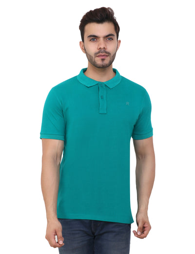 A man wearing a green cotton blend polo t-shirt with a collar and short sleeves.