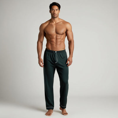 A man wearing dark green cotton pyjama with a relaxed fit and side pockets.